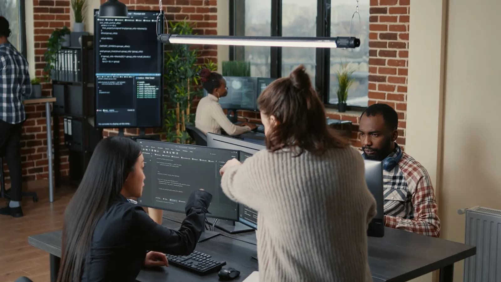 Development team working with no-code platforms in modern office space